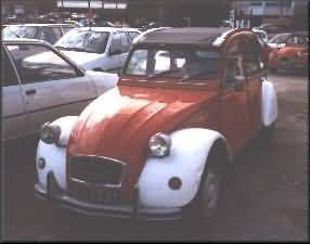 orange and white patrol 2CV, front